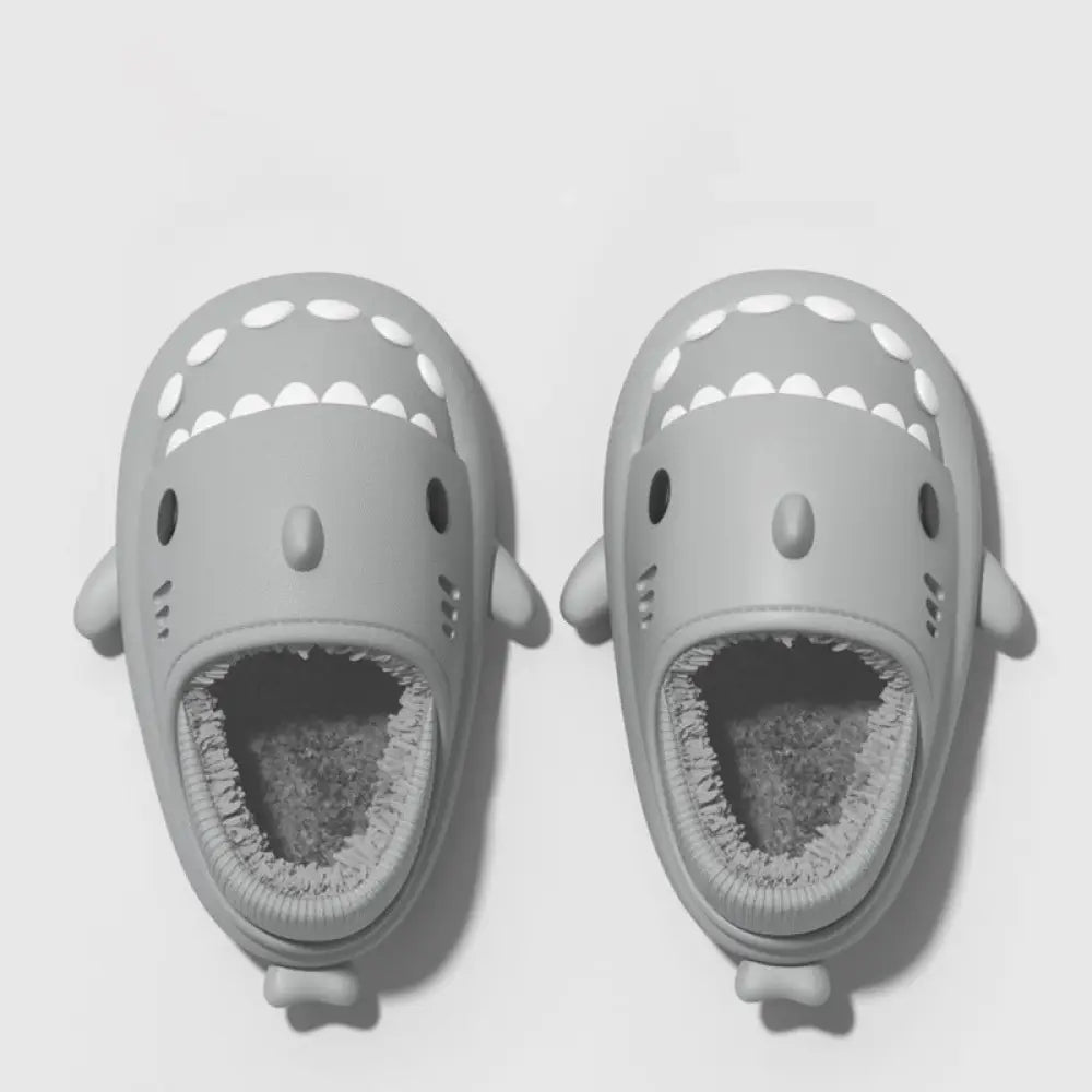 Plush gray shark winter house slippers with white triangular teeth black eyes soft rubber soles and plush interior