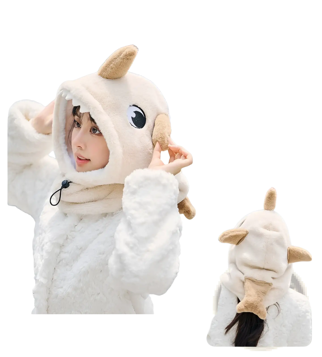 A plush cream-colored dinosaur-themed shark winter hat with tan horns and black eye detail for ear protection