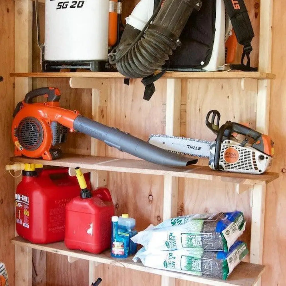 Heavy duty stud mount steel shed shelf brackets kit holding an orange and black stihl chainsaw with a silver blade
