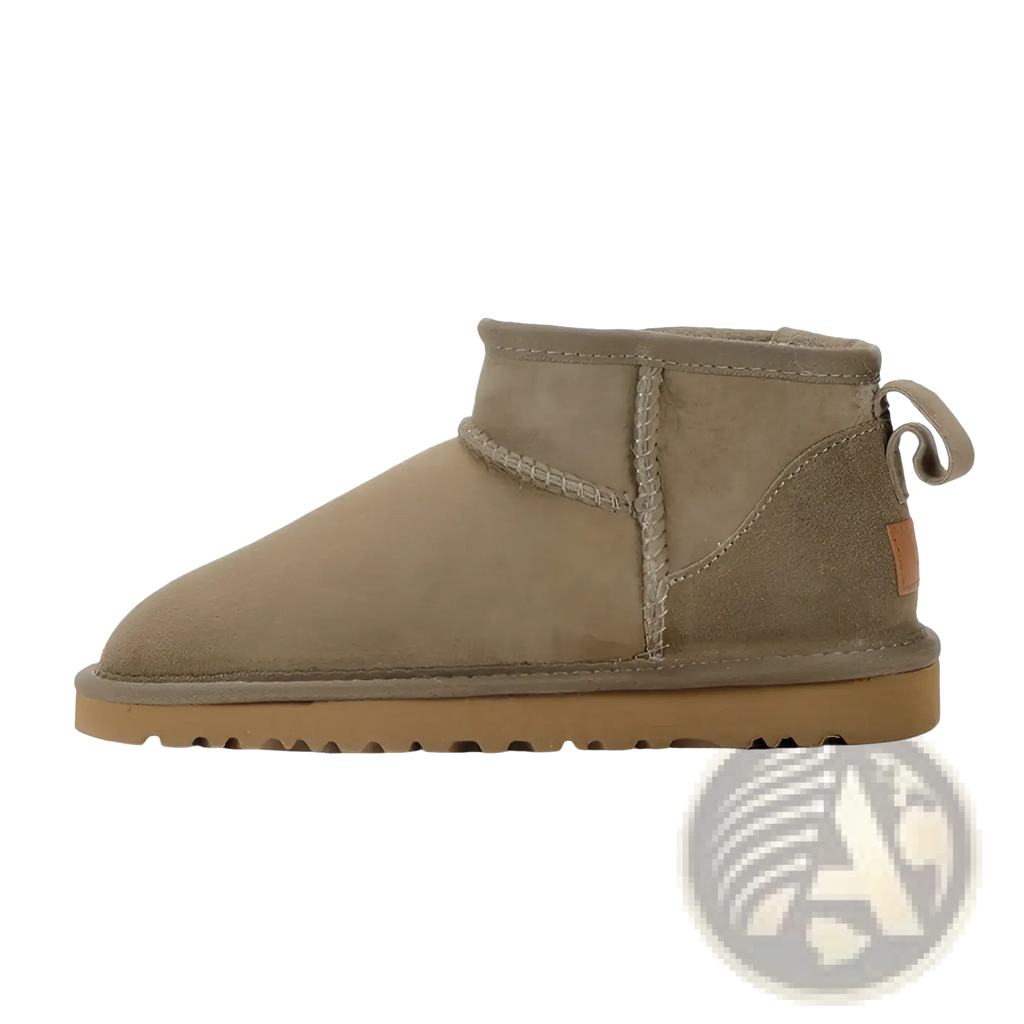 Tan suede sheepskin mini snow boot showing back side with stitched seam and pull tab for easy wear