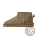 Tan suede sheepskin mini snow boot showing back side with stitched seam and pull tab for easy wear