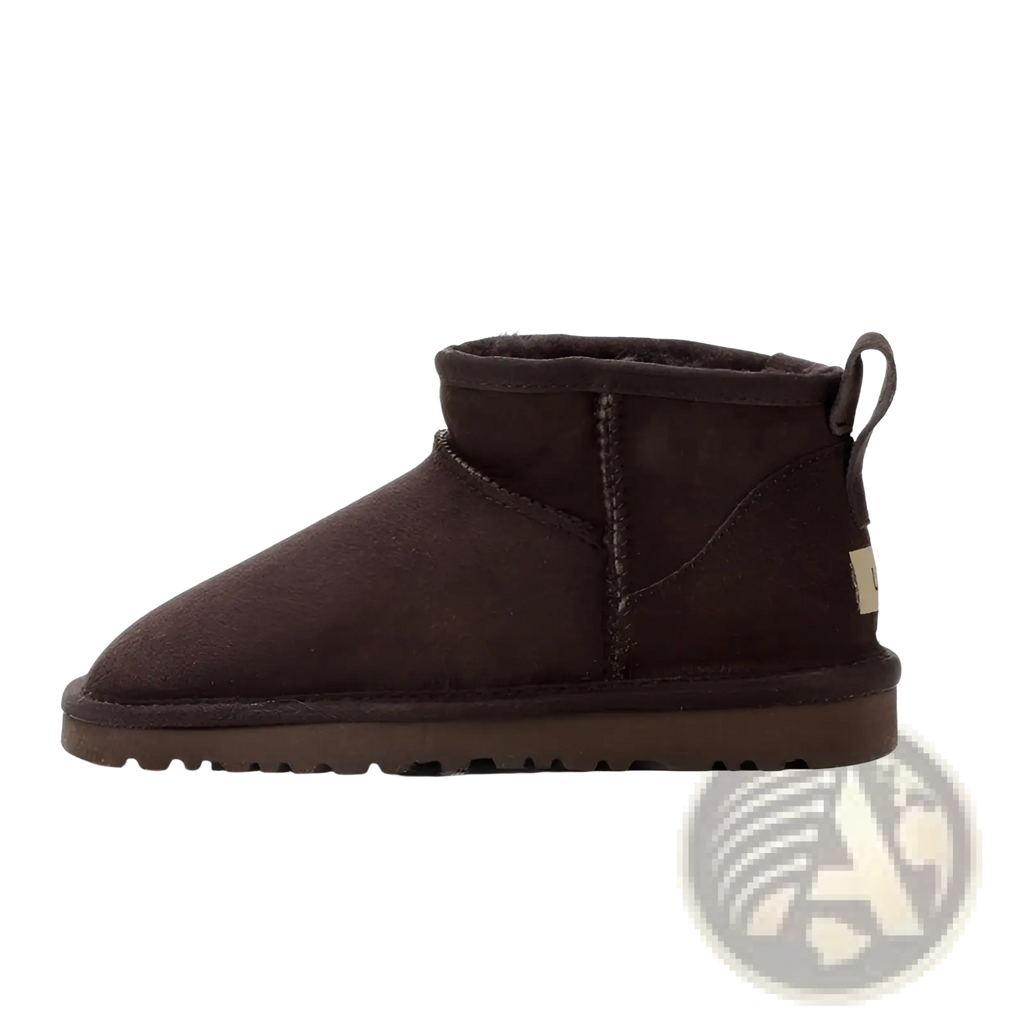 Dark brown suede sheepskin mini snow boot showing back side with plush interior and pull tab for easy wear