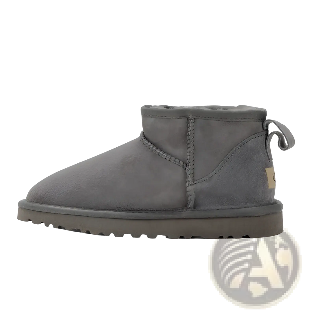 Gray suede sheepskin mini snow boot with plush interior and sturdy rubber sole for cold weather use