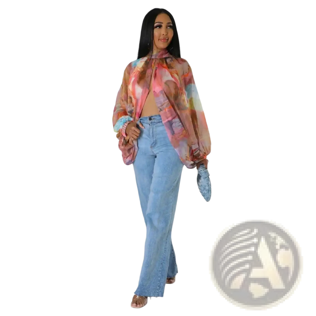 A sheer chiffon blouse with a vibrant pink orange and blue abstract print featuring puffed sleeves and tie neck design