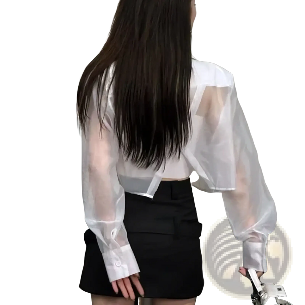 White sheer long-sleeved blouse with cropped fit and solid white cuffs paired with black mesh office jacket