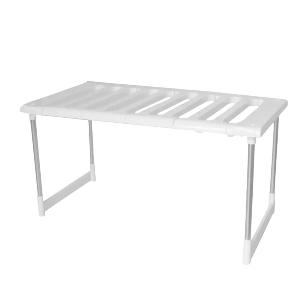 White plastic shelf organizer rack with silver metal legs and slatted top as kitchen storage holder