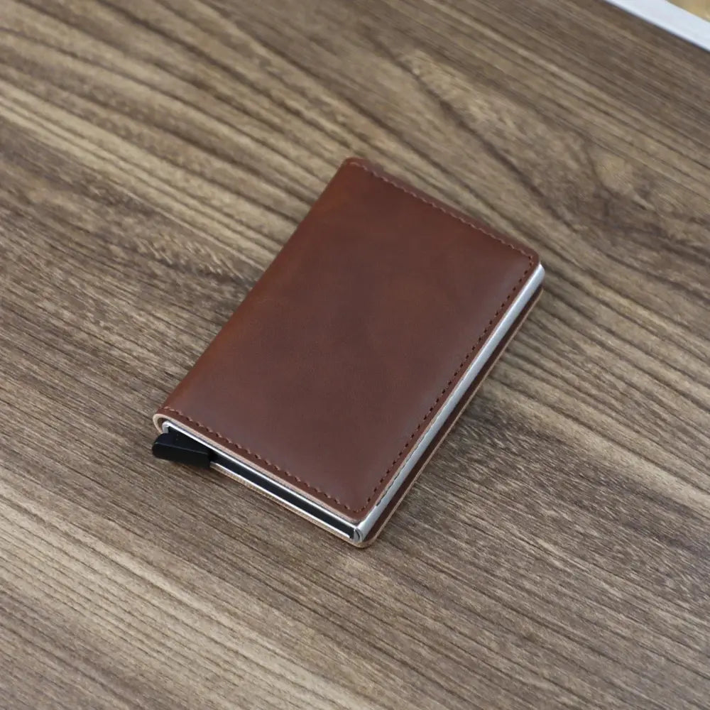 Slim RFID blocking aluminum alloy card case wallet in brown leather with silver metal edges and black magnetic closure