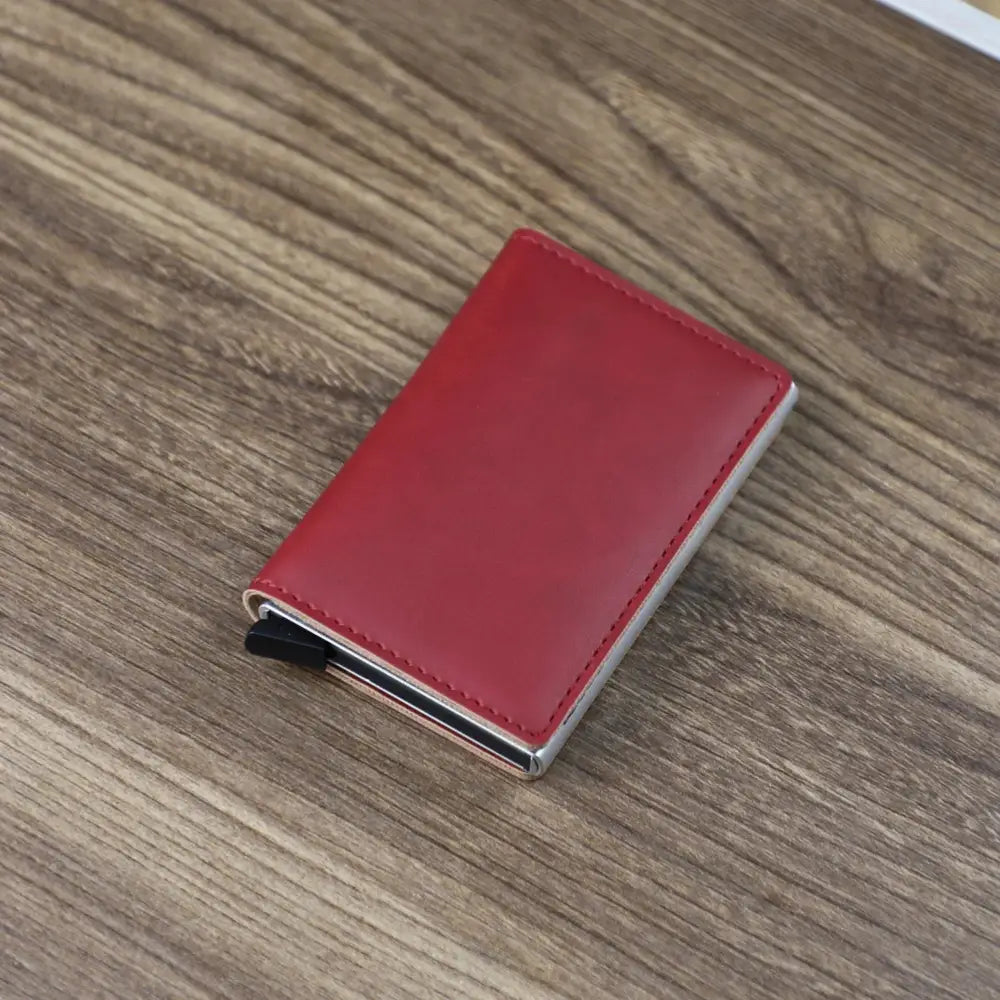 Red leather slim RFID blocking card case wallet with silver metallic edges and black magnetic clasp