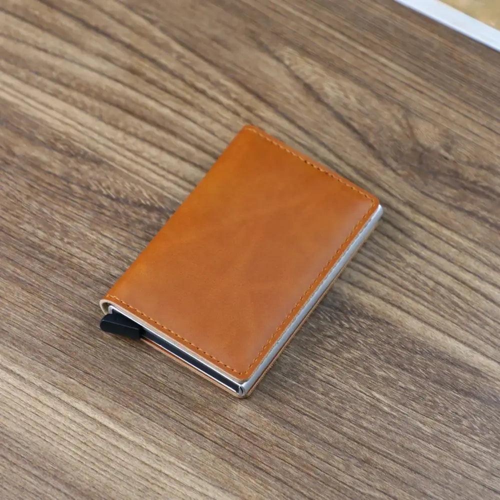 Slim RFID blocking aluminum alloy card case wallet in tan leather with silver metal edges and black magnetic clasp