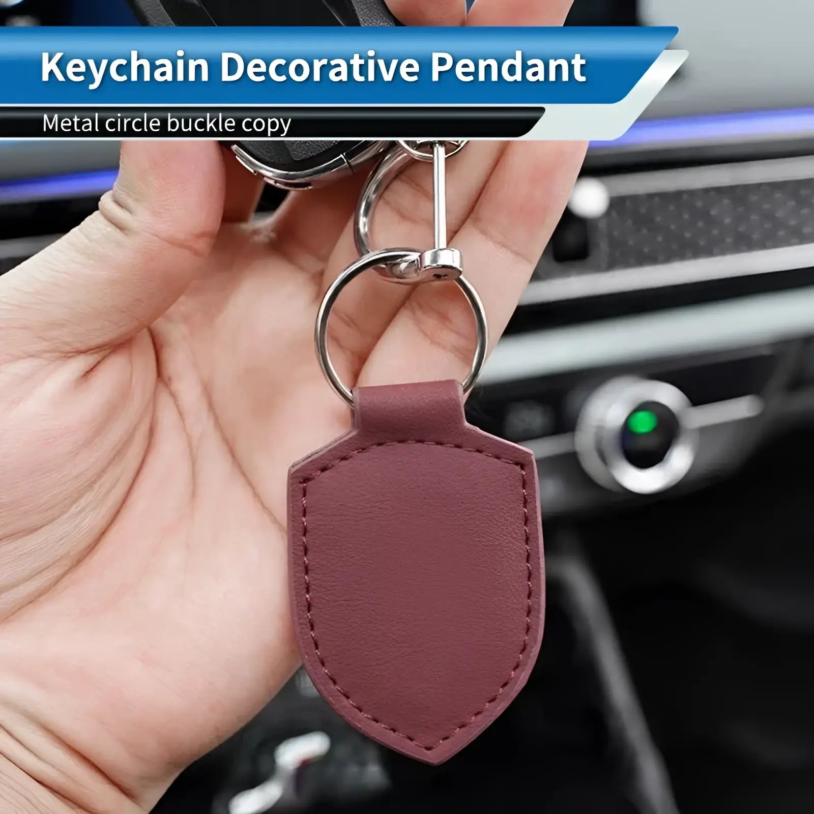 A maroon leather shield-shaped car keychain ring organizer with a metal circle buckle for key management