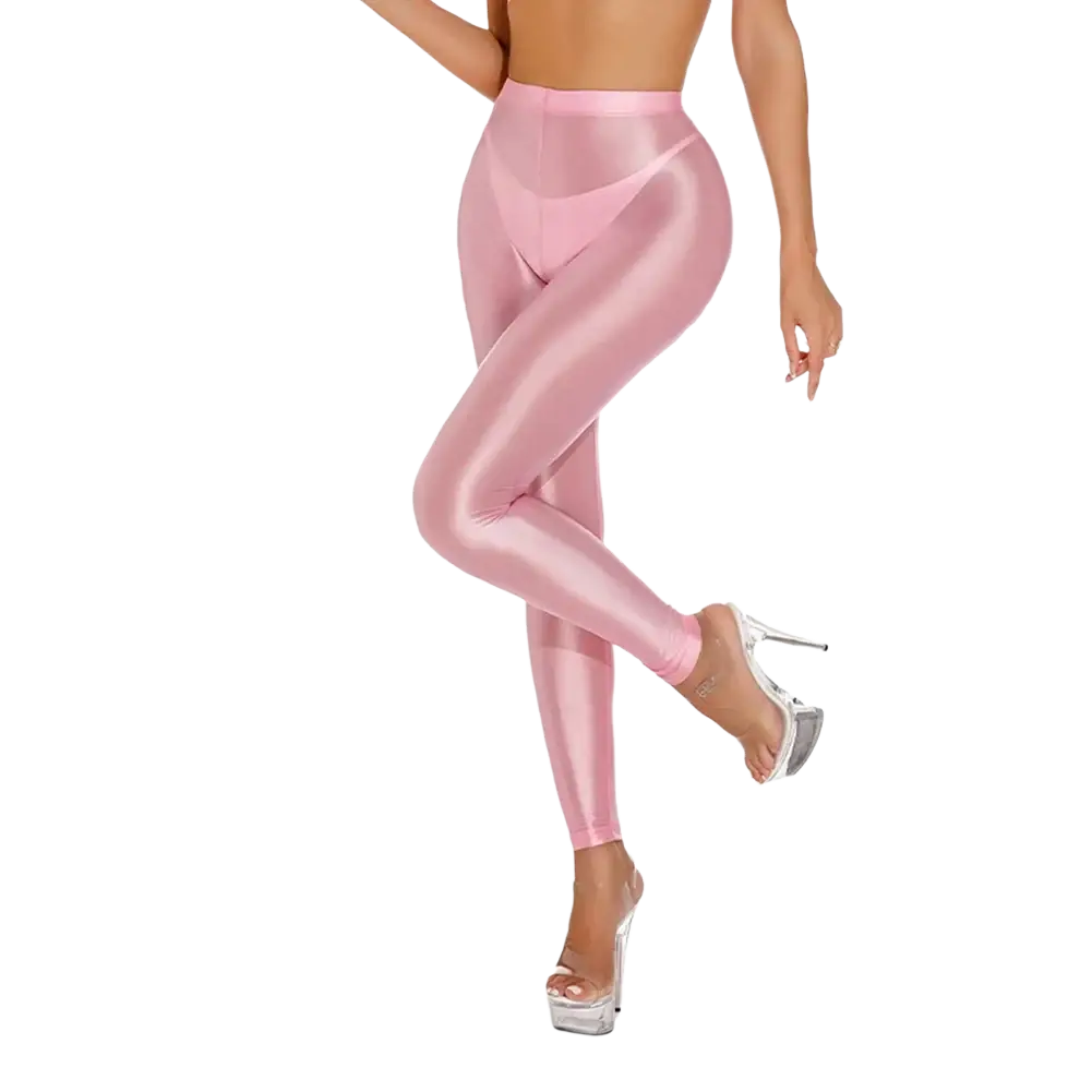 Pink shiny metallic high waisted disco leggings featuring sheer fabric and a sleek, reflective finish