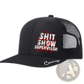 Black trucker hat with mesh back and front panel featuring bold white shit show supervisor text and embroidered courage brim