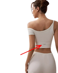 The back of a light-colored off-the-shoulder crop top with a silver silicone mlp logo in a shockproof yoga vest design