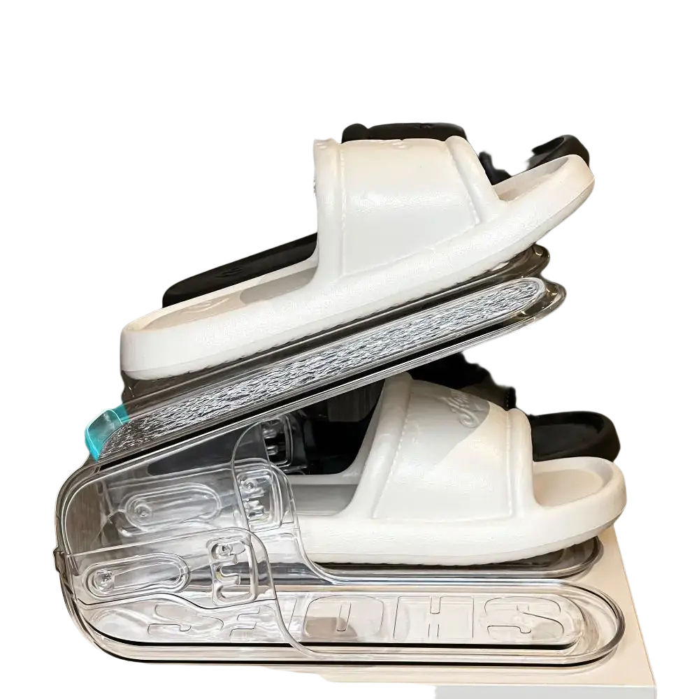 Clear plastic double layer shoe slots organizer holding white and black sandals for efficient shoe rack storage