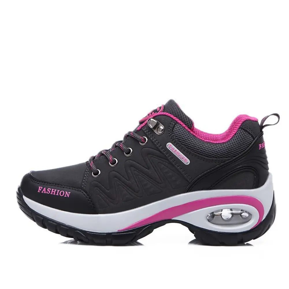 Women’s purple and black air cushion athletic hiking shoe with cushioned air sole, mesh upper, and metallic eyelets