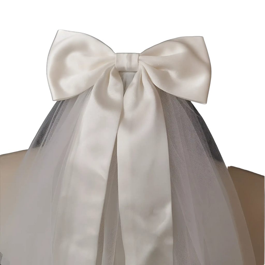 Short bridal veil with a delicate white satin bow and sheer tulle attached to a silver hair comb accessory