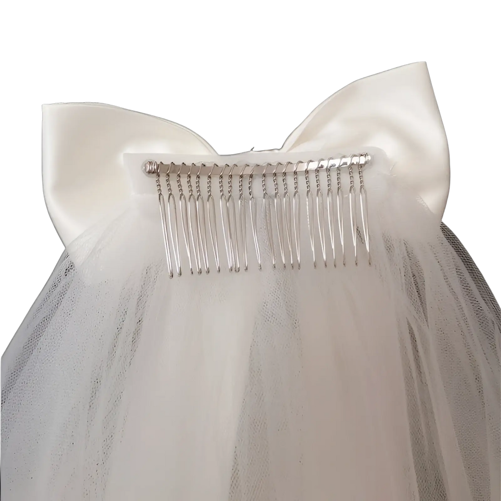 Short bridal veil with delicate white satin bow and silver hair comb attached to the top of elegant tulle fabric