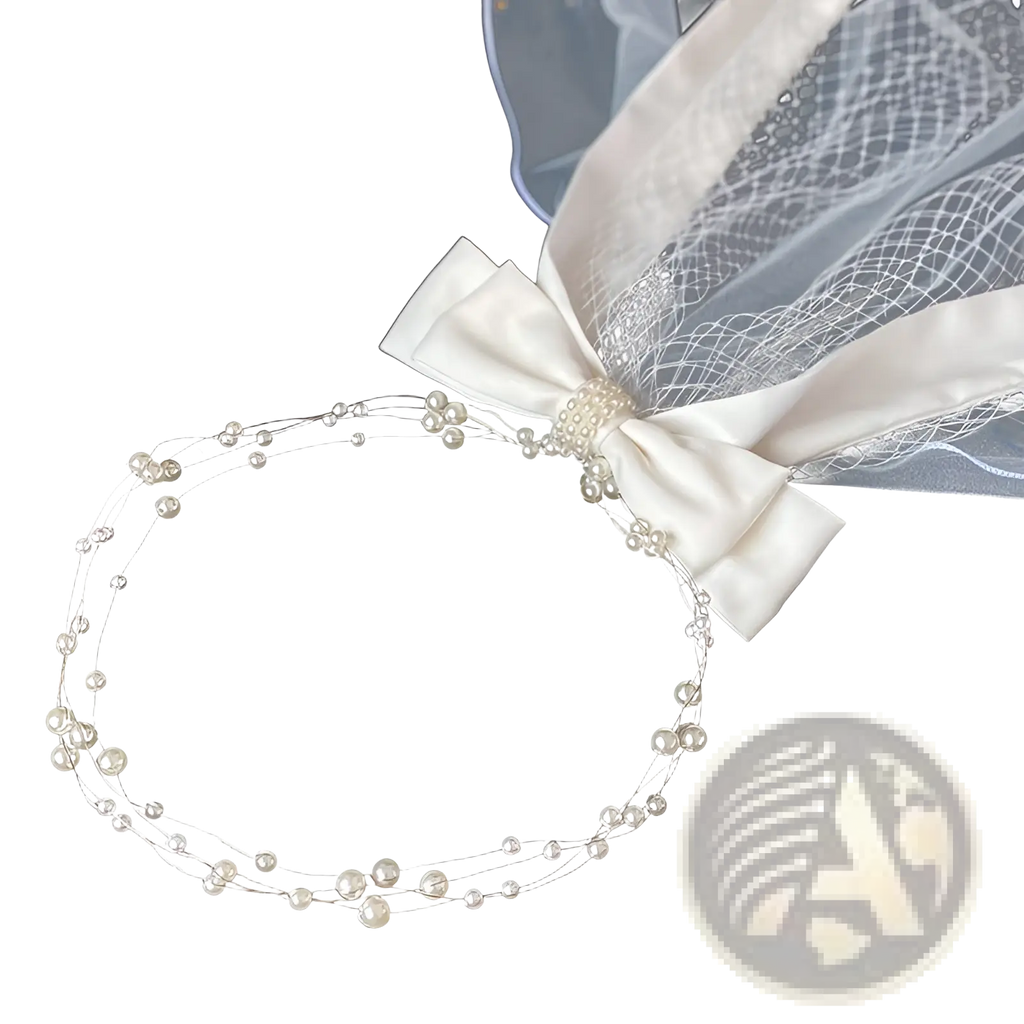 Short bridal veil featuring an ivory satin bow and silver hair comb with delicate pearl and wire details