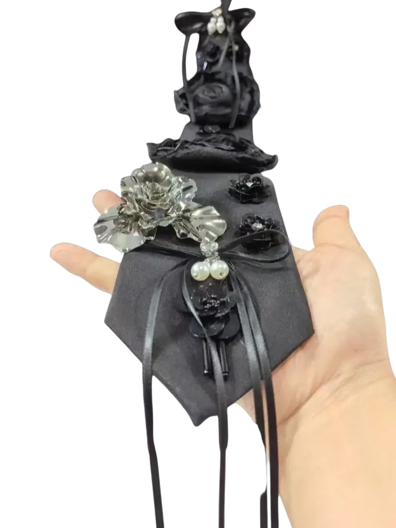 Black fabric pouch with silver and black floral embellishments and pearl accents for women girls ladies sleeve shirts blouses