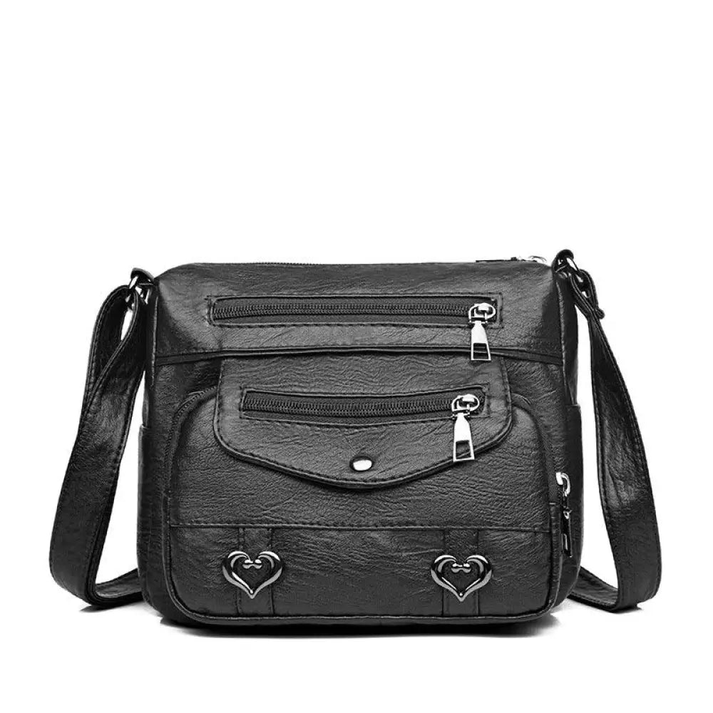 Black faux leather crossbody bag with silver heart-shaped studs and multiple zippers for women with multi pockets