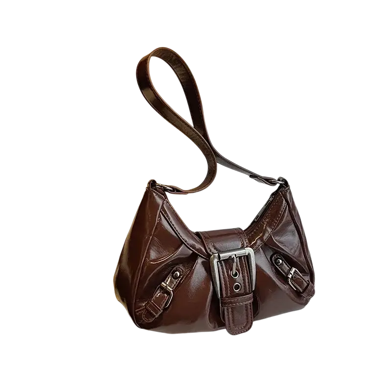Brown leather shoulder bag with silver buckle and adjustable strap in patent leather saddle design for women