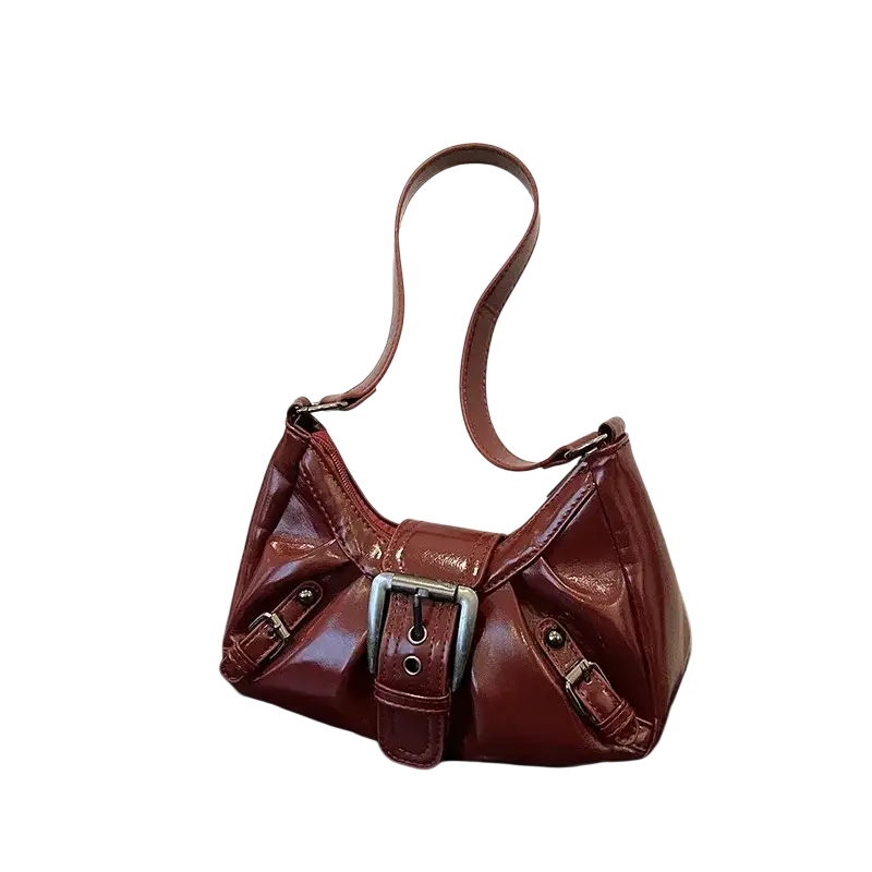 Glossy burgundy leather shoulder bag with silver buckle and metallic hardware in brown patent leather saddle style for women