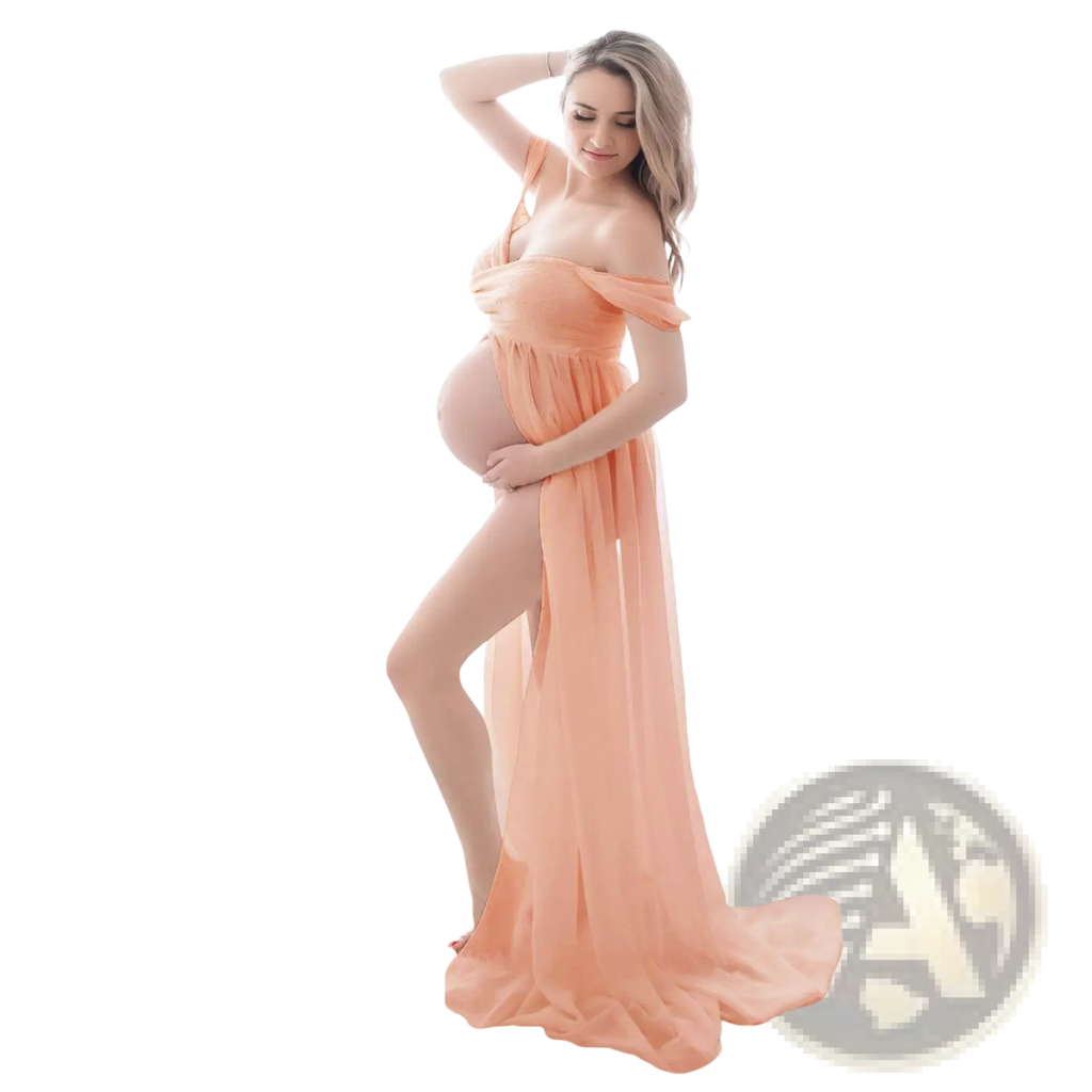 A flowing peach-colored chiffon maternity gown with off the shoulder straps and a high slit for photoshoots