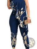 Navy blue one-shoulder ruffled jumpsuit with a flowing cream and white leaf-patterned overlay