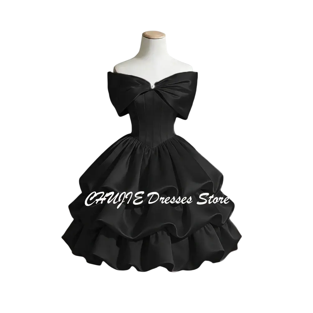 Black satin off-shoulder graduation dress with a large bow neckline and tiered ruffles