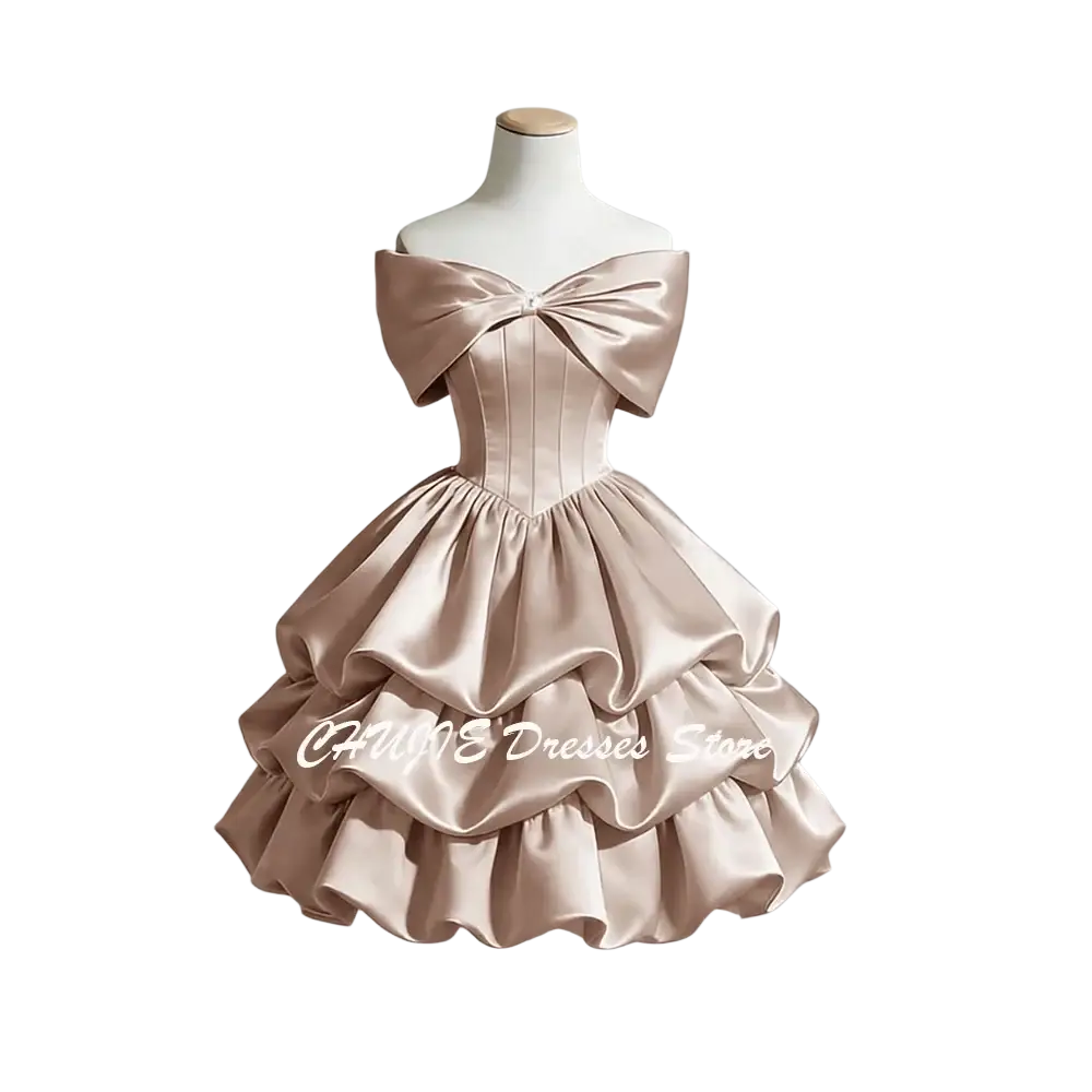 A blush satin off-shoulder graduation dress with a structured bodice and tiered ruffle skirt