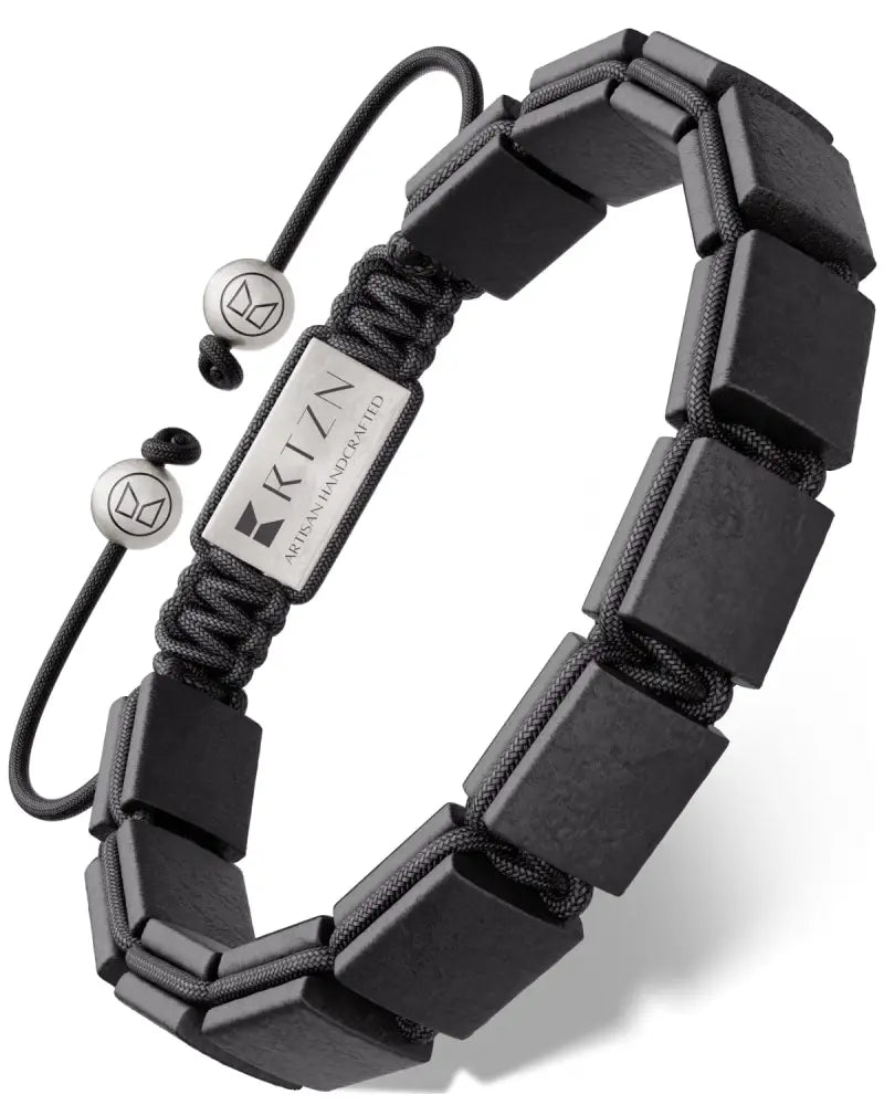 Black rectangular shungite stone beads bracelet on black paracord with silver metal tags and spherical end caps for emf protection