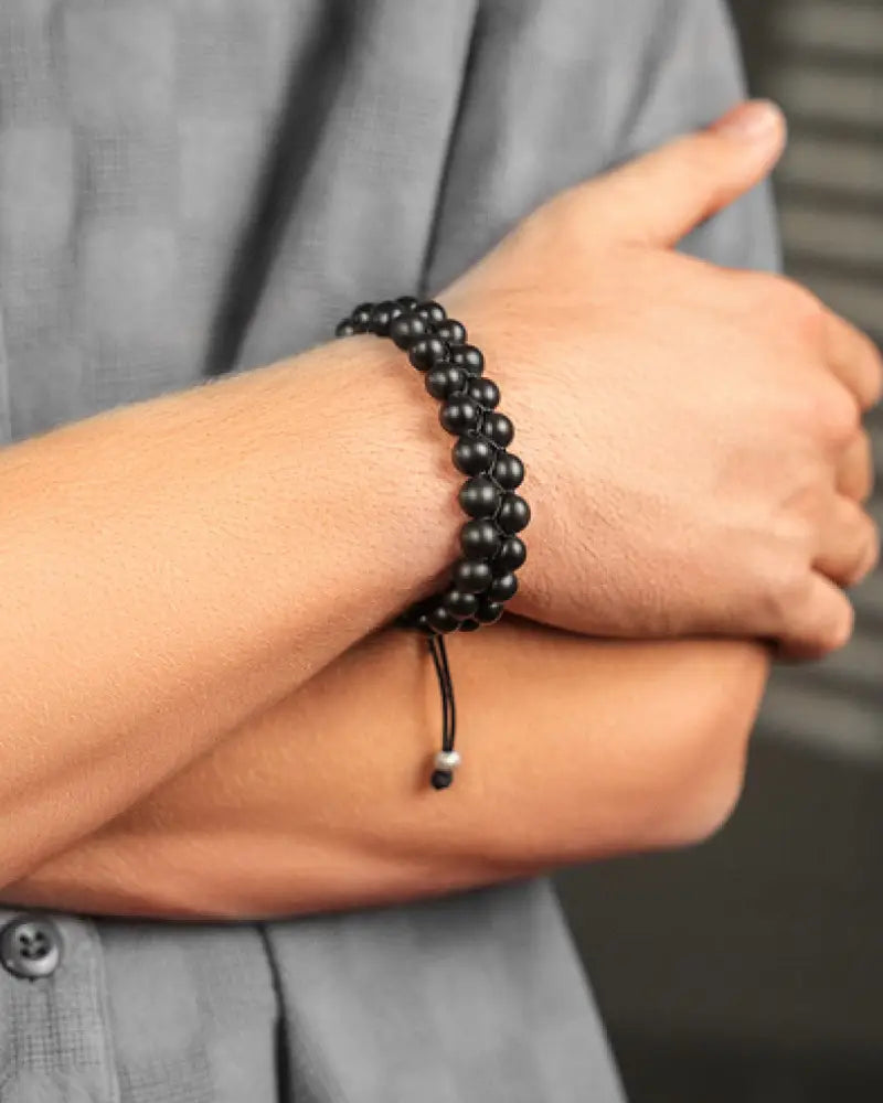 Adjustable shungite emf protection beaded bracelet with black smooth round stones and silver-toned toggle clasp