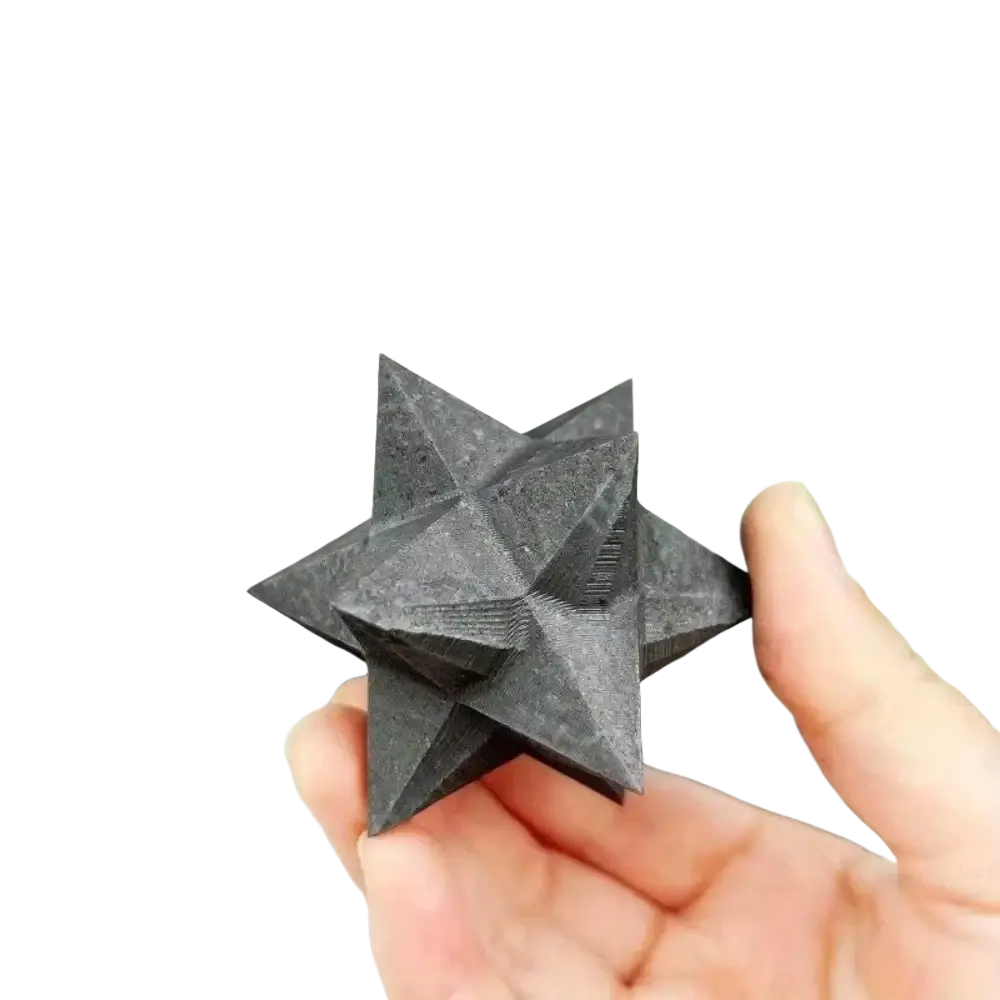 Black shungite merkaba crystal with textured geometric facets for modern decoration style and home decor
