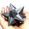 A dark gray shungite merkaba crystal with intricate geometric engravings for elegant home decor and decoration style