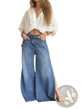 Wide-leg blue denim jeans with side slit and raw hem showcasing casual stylish design