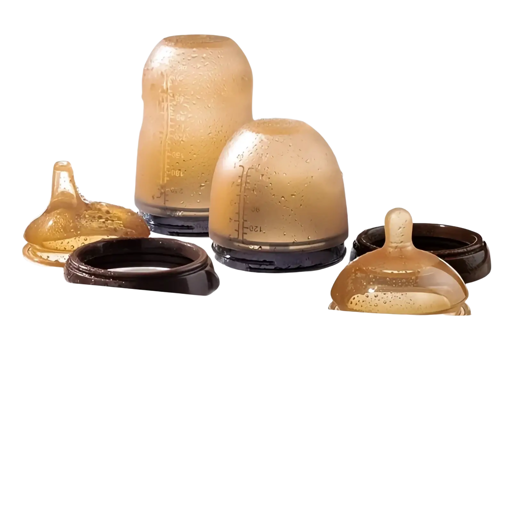 Transparent amber silicone baby bottle nipples with black bases arranged in a white steamer for 150ml bottles with handle