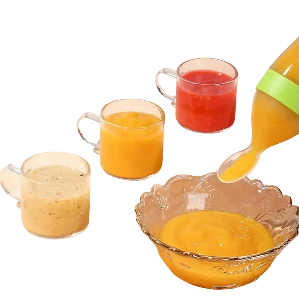 A clear glass pitcher with a bright green silicone grip pouring orange puree into a scalloped glass bowl