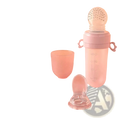 Pink silicone baby squeeze feeding bottle with clear dotted teething ball and matching handles for easy grip