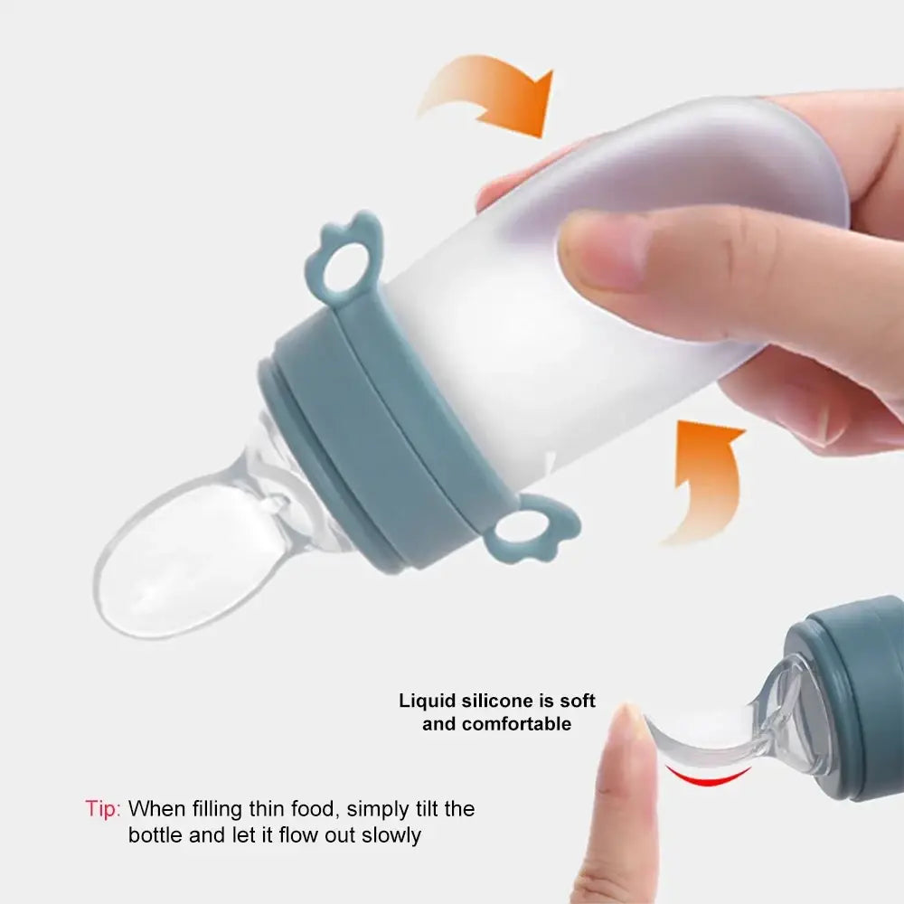 Silicone baby squeeze feeding bottle and spoon feeder with translucent silicone feeder and teal soft grip handle