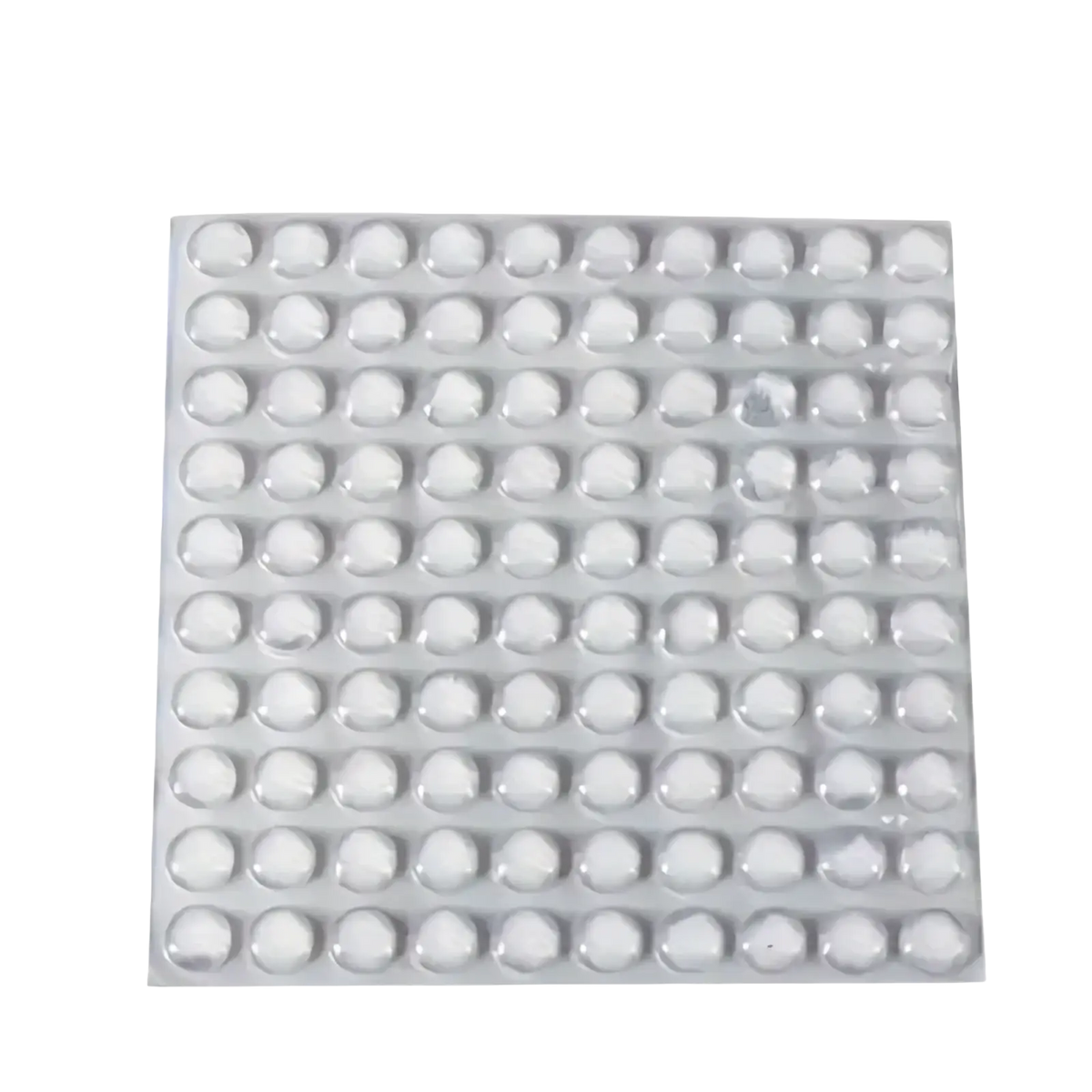 A sheet of 100 clear silicone bumpers transparent round dome shaped protective furniture pads arranged in a grid pattern