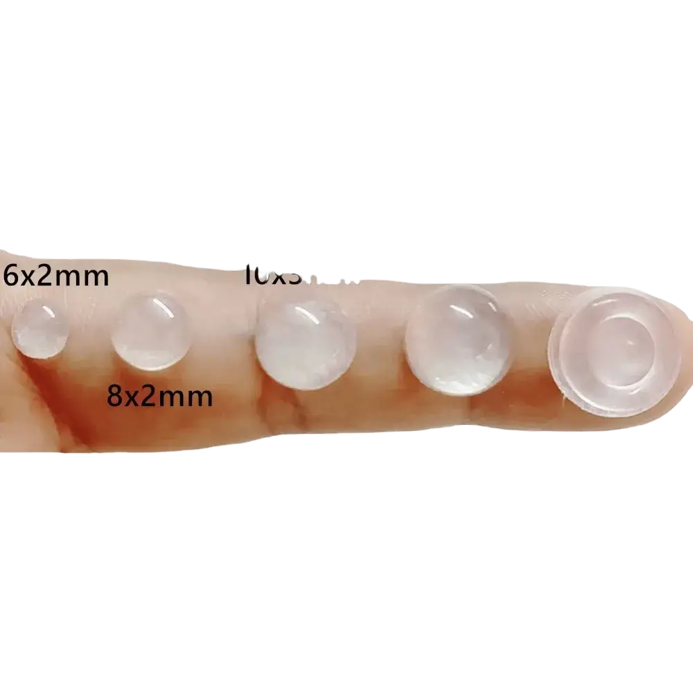Clear translucent silicone cabinet bumpers in various sizes displayed on a finger for protective cushioning