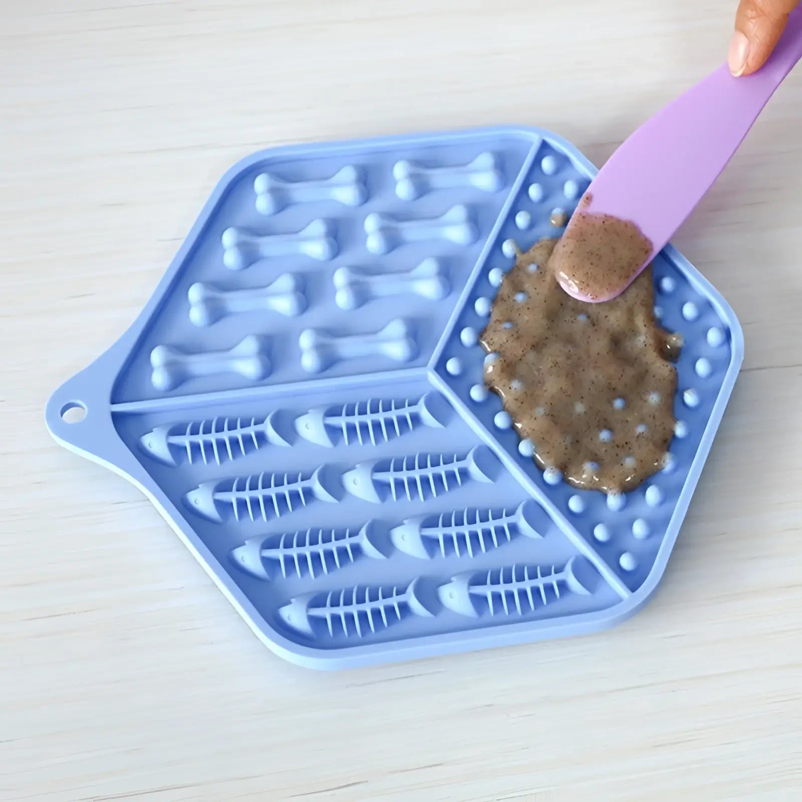 Light blue silicone dog lick mat puzzle feeding pad with bone and fish skeleton patterns for pet feeding
