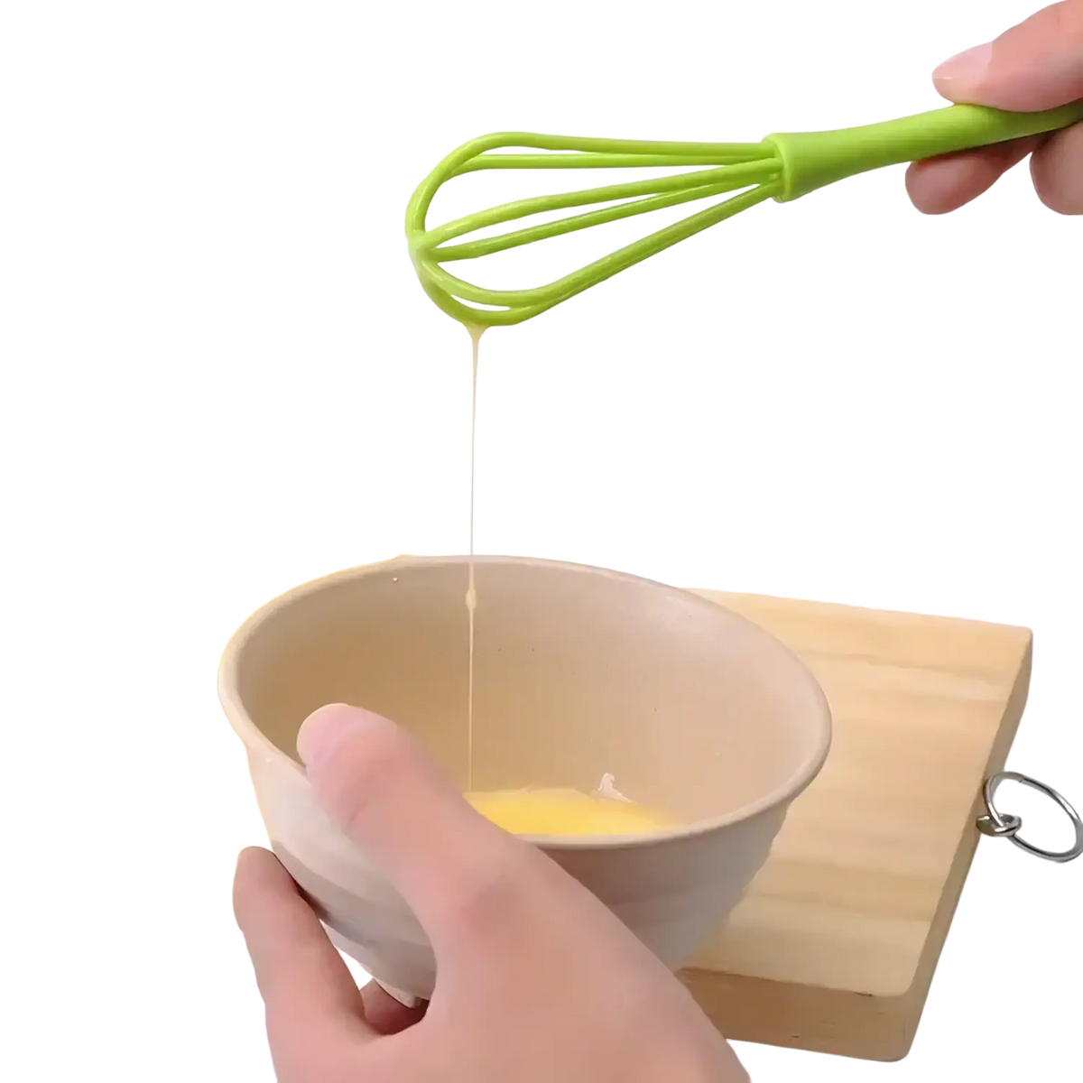 Bright green silicone egg whisk mixing egg mixture in a beige bowl kitchen hand mixer tool