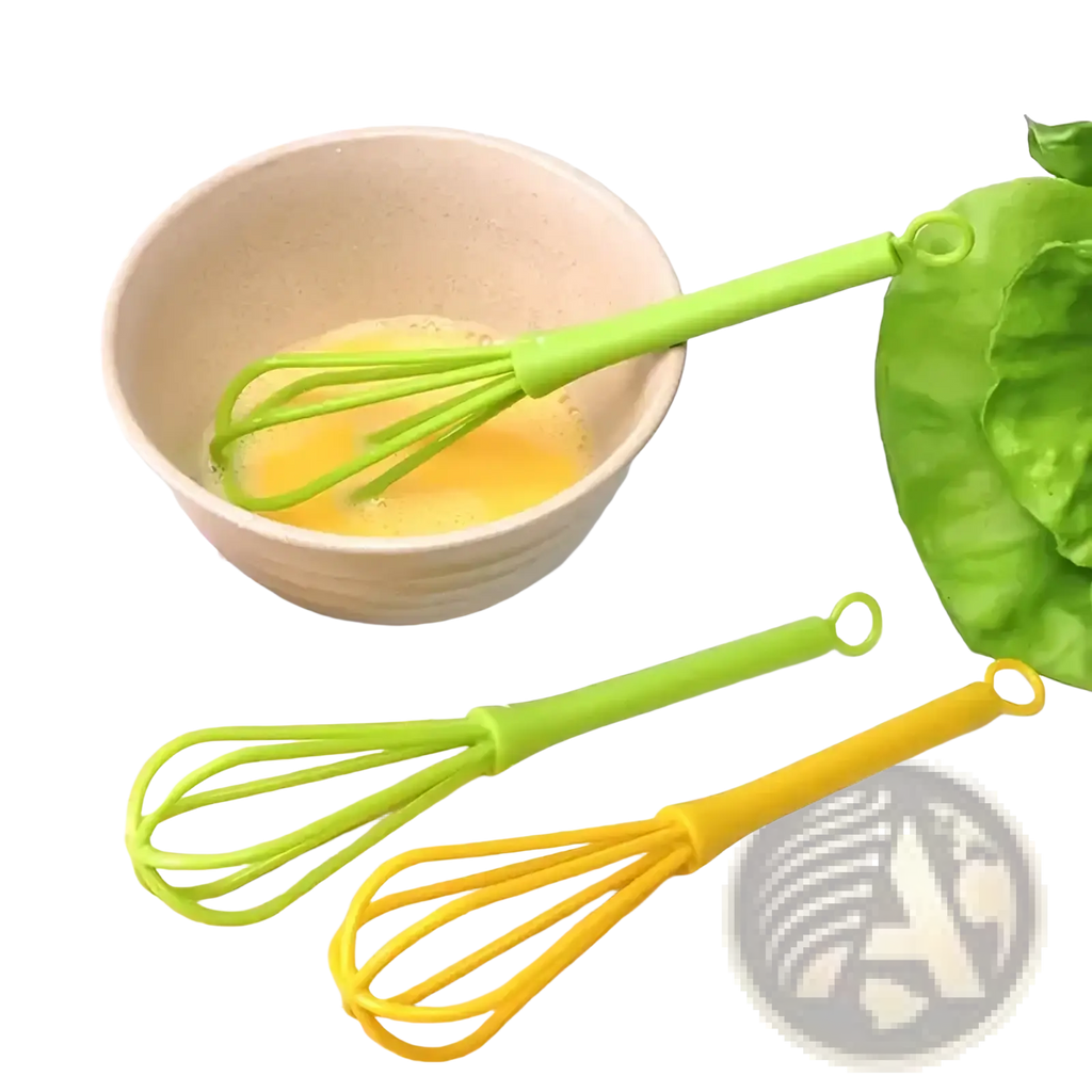 Bright green and yellow silicone egg whisk kitchen hand mixer tool with flexible wire whisks on a wooden board