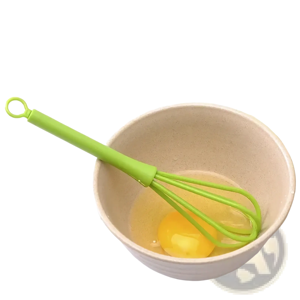Green silicone egg whisk resting in beige ceramic bowl with cracked yolk kitchen hand mixer tool
