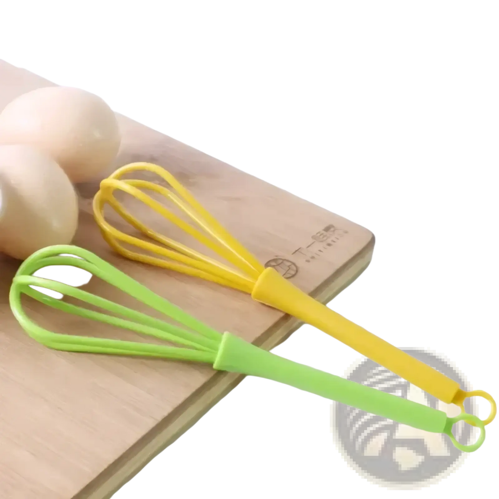 Two colorful silicone egg whisk kitchen hand mixer tools in yellow and lime green resting on a wooden cutting board