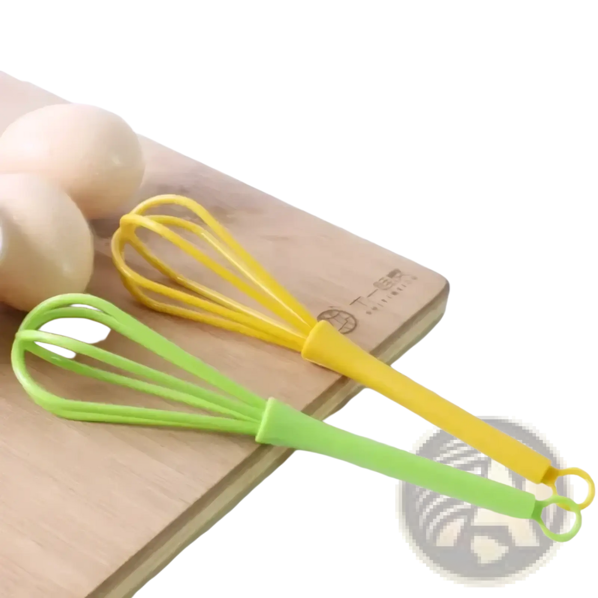 Two colorful silicone egg whisk kitchen hand mixer tools in yellow and lime green resting on a wooden cutting board