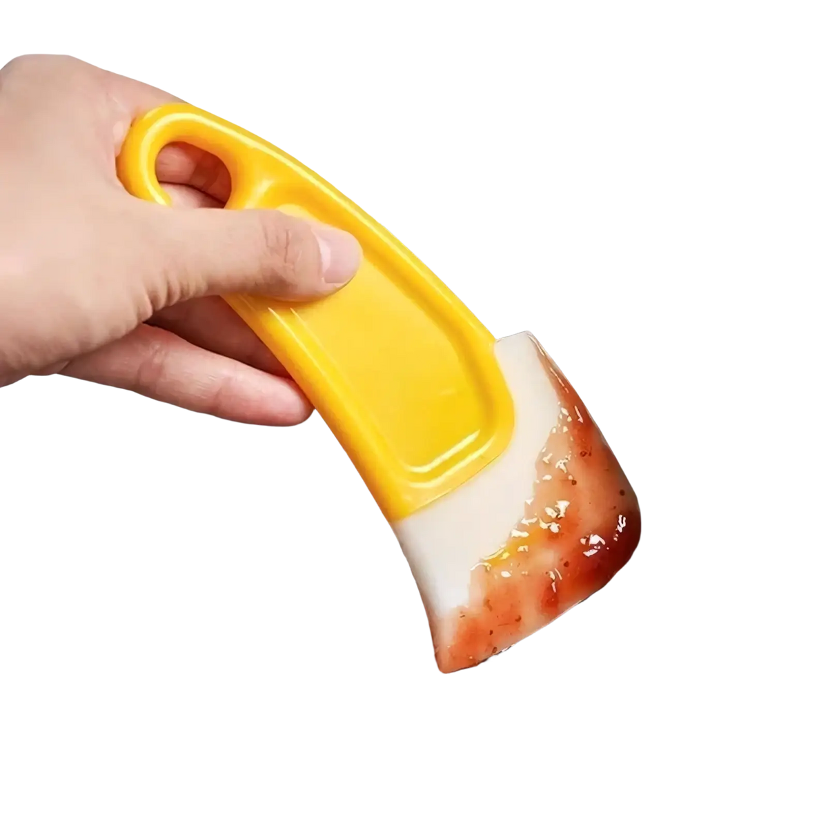 Yellow silicone kitchen pan scraper with white curved blade coated in red sauce for dish cleaning and scraping