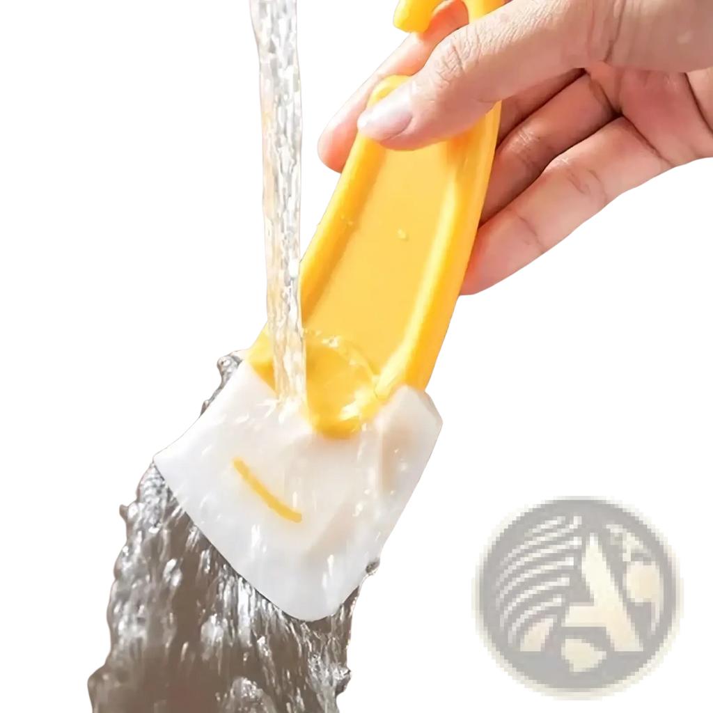 Yellow and white silicone kitchen pan scraper and dish cleaner tool with a smiling face design for dishwashing