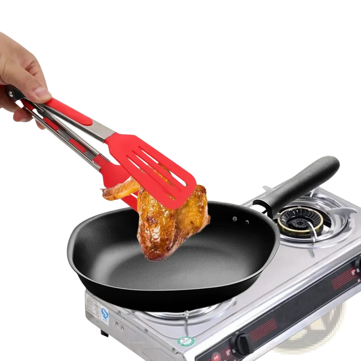 Red silicone kitchen tongs with stainless steel handles lifting roasted chicken from a black non-stick frying pan